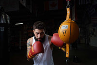 variant:6"::TITLE Boxing Double End Bag kid hitting double end bag with fighting gloves