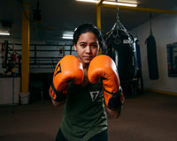 variant:orange/black::TITLE Boxing Dauntless Training Gloves boxing stance