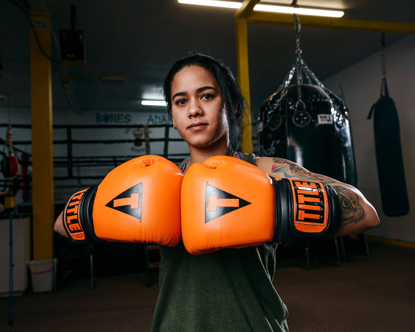 variant:orange/black::TITLE Boxing Dauntless Training Gloves hands together 