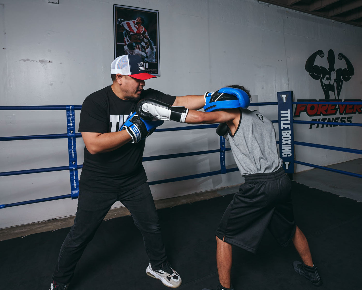 variant:lifestyle::TITLE Boxing Dual Purpose Combo Punch Mitts coach with boxer boxer left jab