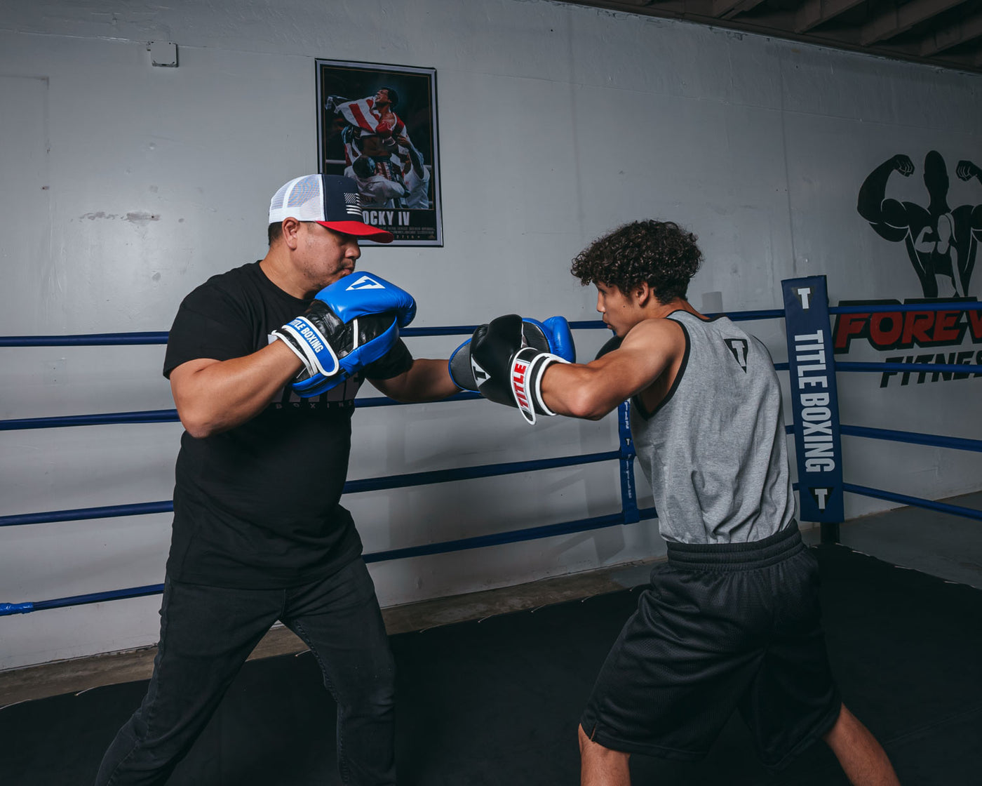 variant:lifestyle::TITLE Boxing Dual Purpose Combo Punch Mitts coach with boxer left hook