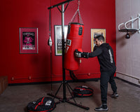 variant:lifestyle::TITLE Double Trouble Heavy Bag Stand red bag haning with speedbag Rudy hitting bag