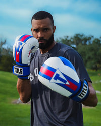 variant:Blue/White/Red::TITLE Boxing World Bag Boxing Gloves on boxer's hands in fighting stance