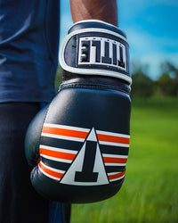 variant:Navy/White/Orange::TITLE Boxing World Bag Boxing Gloves on boxer's hand closeup
