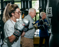variant:lifestyle::TITLE Boxing Fight Back Boxing Gloves side view of class
