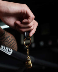 variant:gold::TITLE Boxing Luxury Glove Keyring lady holding.