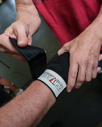 variant:black::TITLE Boxing Fight Back Semi-Elastic Hand Wraps wrapping hands