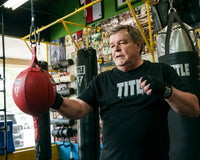 variant:black::TITLE Boxing Fight Back Semi-Elastic Hand Wraps guy double end 