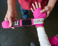 variant:Pink::TITLE Boxing Fight Back Semi-Elasitc Hand Wraps wrapping hands