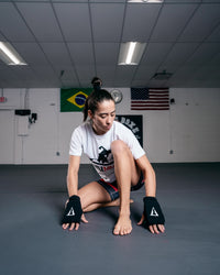 variant:black::TITLE Boxing Fist Guards girl kneeling
