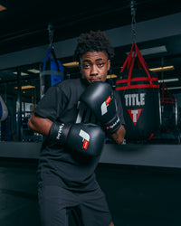 variant:black::Fighting Leather Heavy Bag Gloves boxing pose