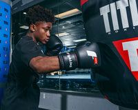 variant:black::Fighting Leather Heavy Bag Gloves right jab on bag