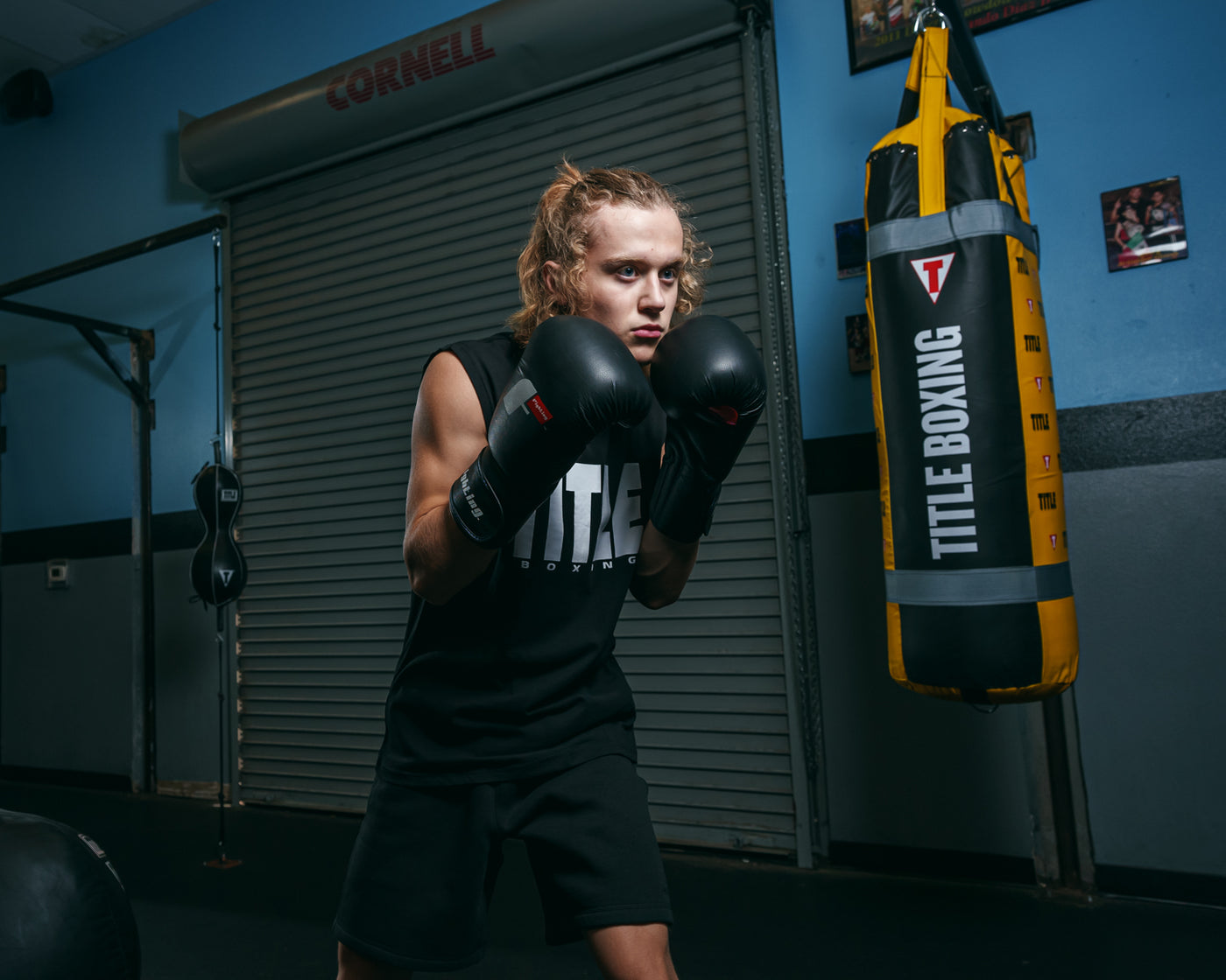 variant:black::Fighting Leather Training Gloves fifth view kid boxing pose