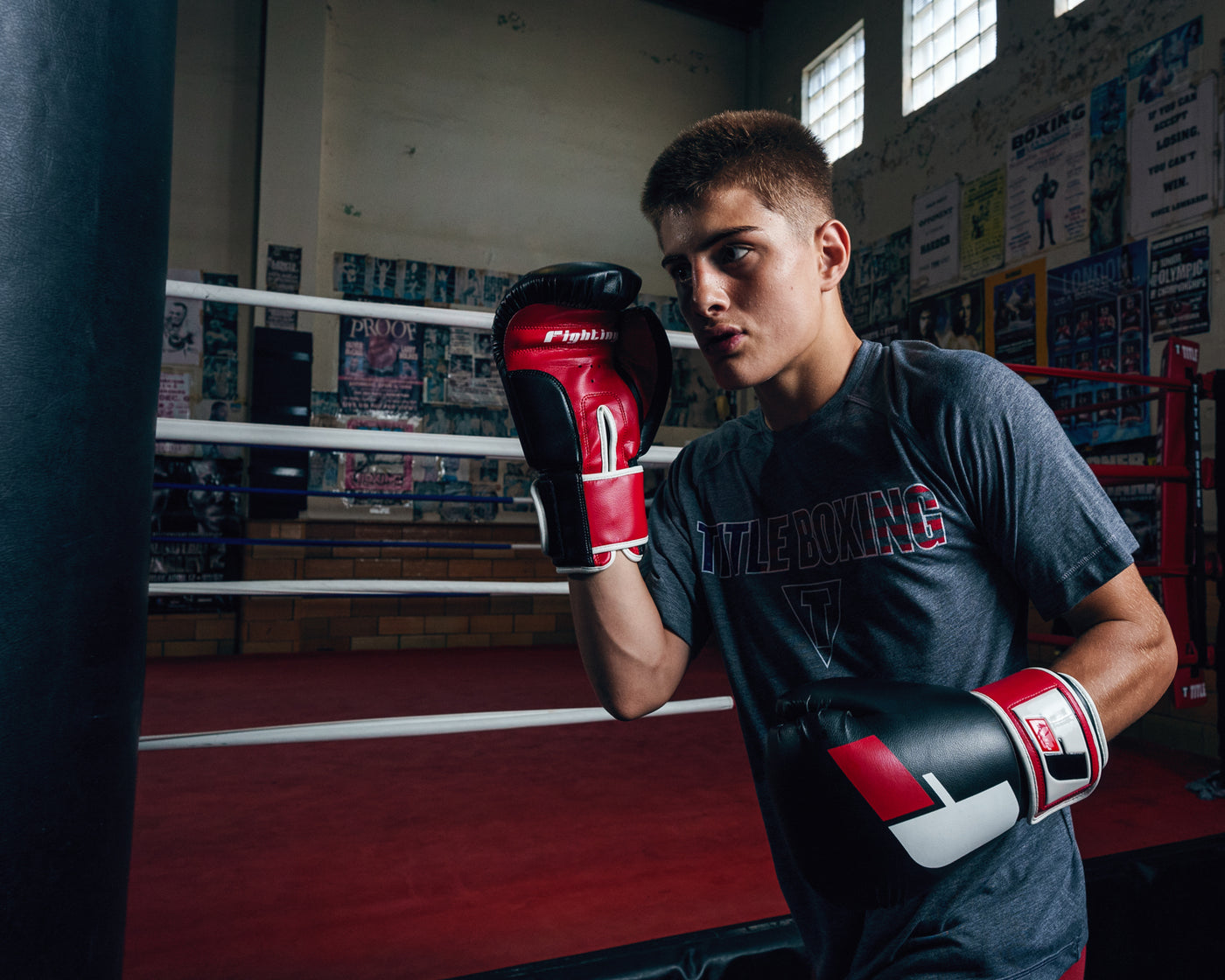 variant:black/red/white::Fighting Big Logo Boxing Gloves kid boxing pose by bag