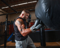 variant:black/grey/white::Fighitng Big Logo Boxing Gloves guy hitting bag right jab