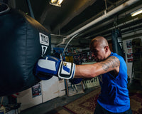 variant:blue/black/white::Fighting Big Logo Boxing Gloves guy hitting bag