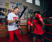 variant:lifestyle::Fighting Combat Striking Sticks kid on right with coach on left