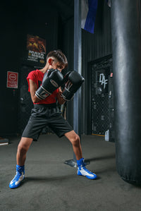 variant:black::Fighting Fury Professional Training Gloves kid hitting bag