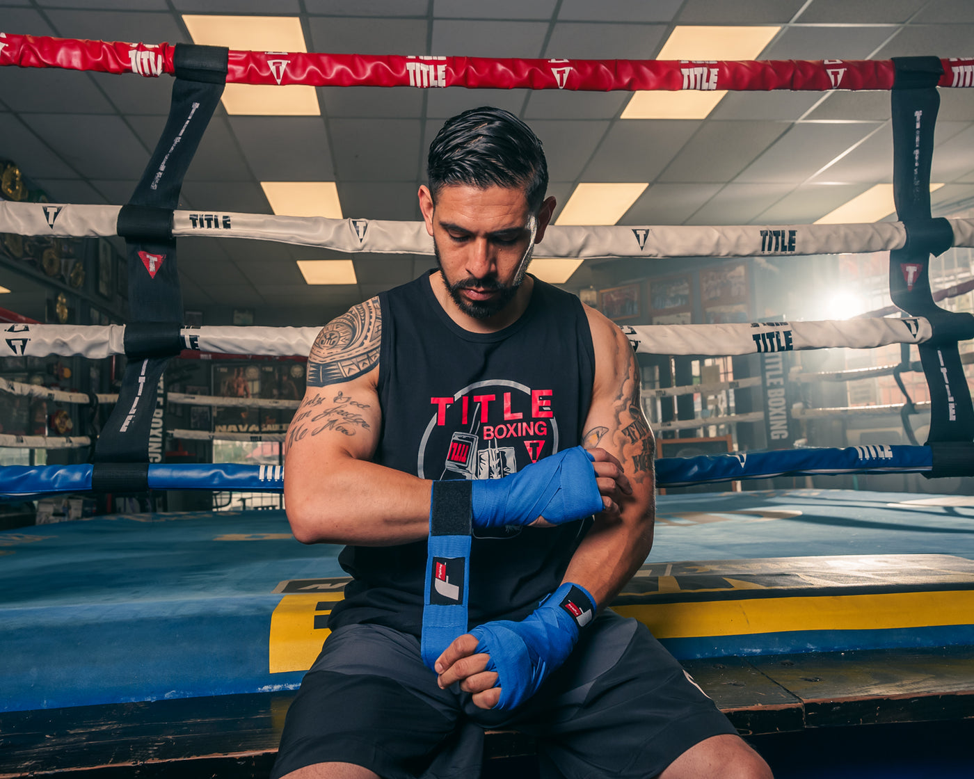 variant:lifestyle::Fighting Sports Gloves and Wraps Bundle fighter wrapping hands with royal blue wraps