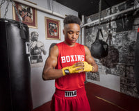 variant:lifestyle::Fighting Sports Gloves and Wraps Bundle gold wraps on boxers hands in the gym