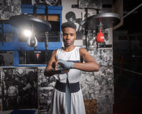 variant:lifestyle::Fighting Sports Gloves and Wraps Bundle fighter wrapping hands with grey wraps