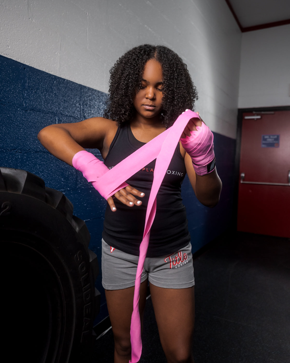 variant:lifestyle::Fighting Sports Gloves and Wraps Bundle boxer wrapping hands with pink wraps