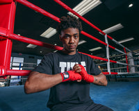 variant:lifestyle::Fighting Sports Gloves and Wraps Bundle red wraps on fighter outside of the ring