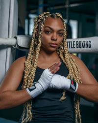 variant:lifestyle::Fighting Sports Gloves and Wraps Bundle white wraps on fighter standing next to ring