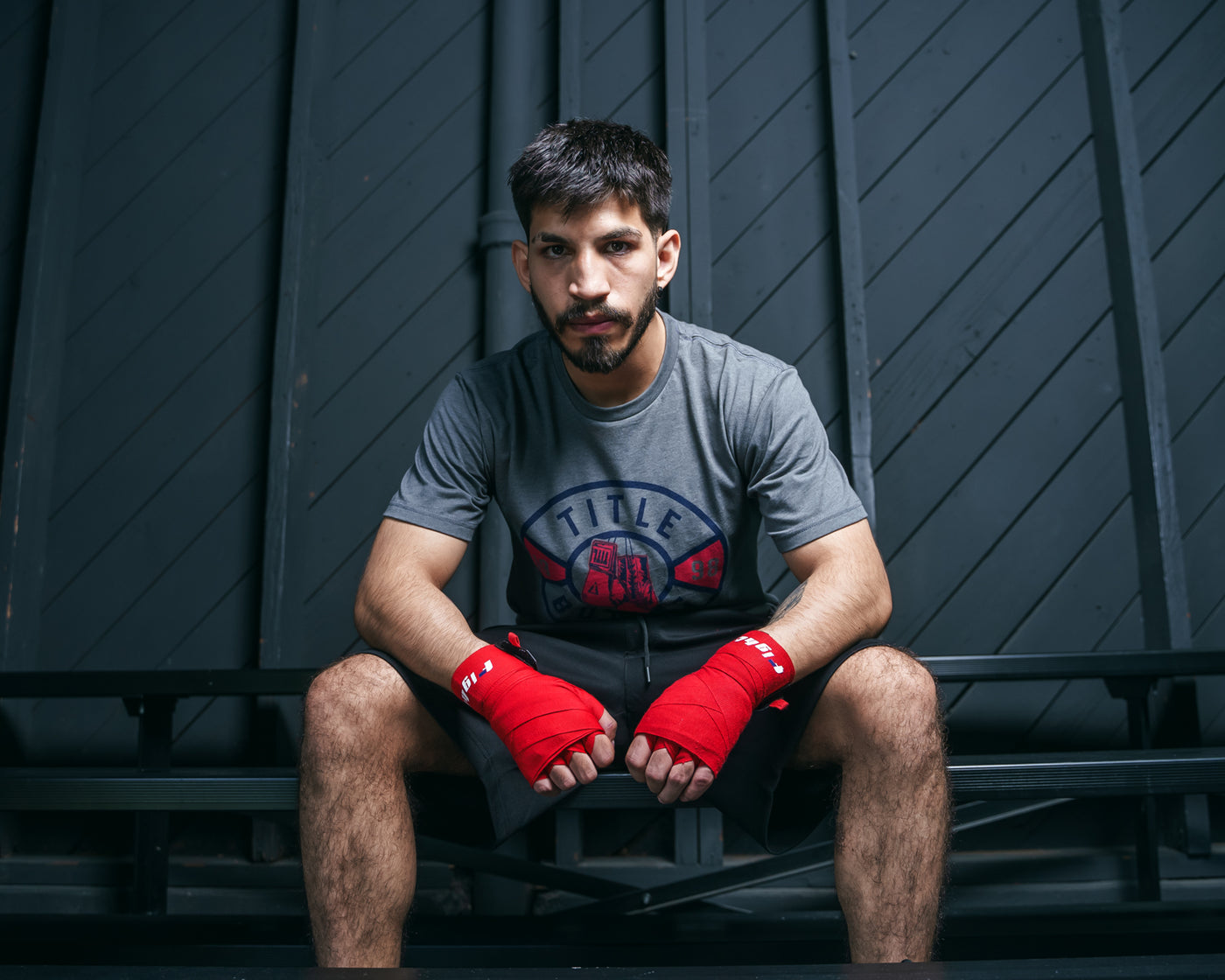 variant:Red::Fighting Semi-Elastic 180" Hand Wraps boy between hand wraps boxer sitting down