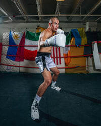 variant:White::Fighting Fearless Certified Pro Fight Gloves II guy boxing right jab