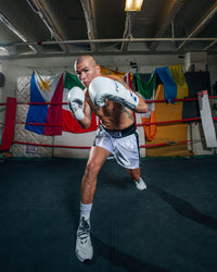 variant:White::Fighting Fearless Certified Pro Fight Gloves II guy boxing stance