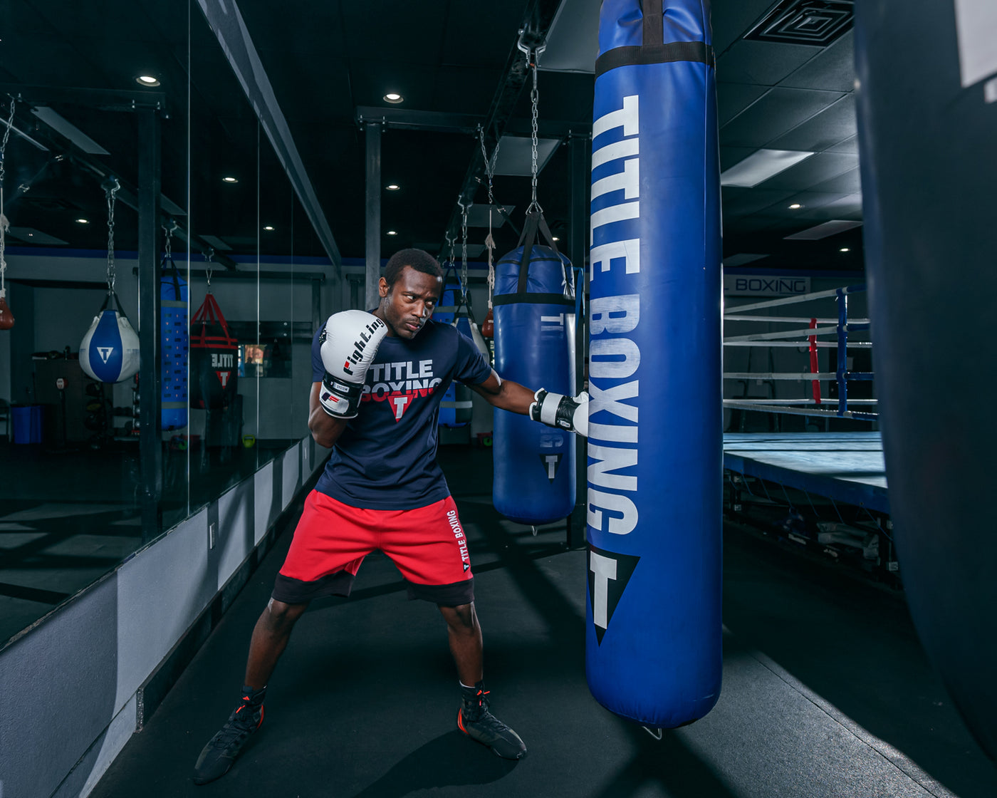 variant:White/Black::Fighting S2 GEL Power Sparring Gloves hitting blue bag
