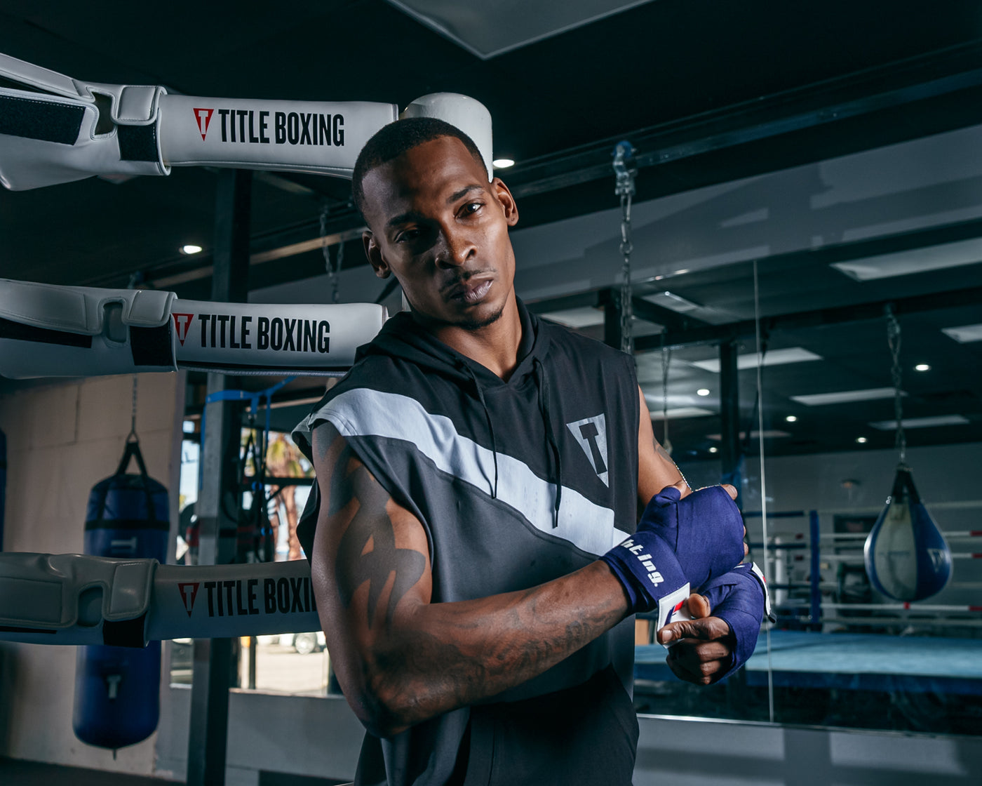 variant:blue/white::Fighting 180" Semi Elastic Hand Wraps guy looking at camera putting on
