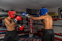 variant:blue::TITLE Boxing Headgear and Groin Protector Bundle on fighters in the ring second view