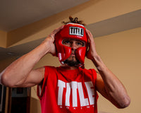 variant:red::TITLE Boxing Headgear and Groin Protector Bundle closeup of red headgear on boxer