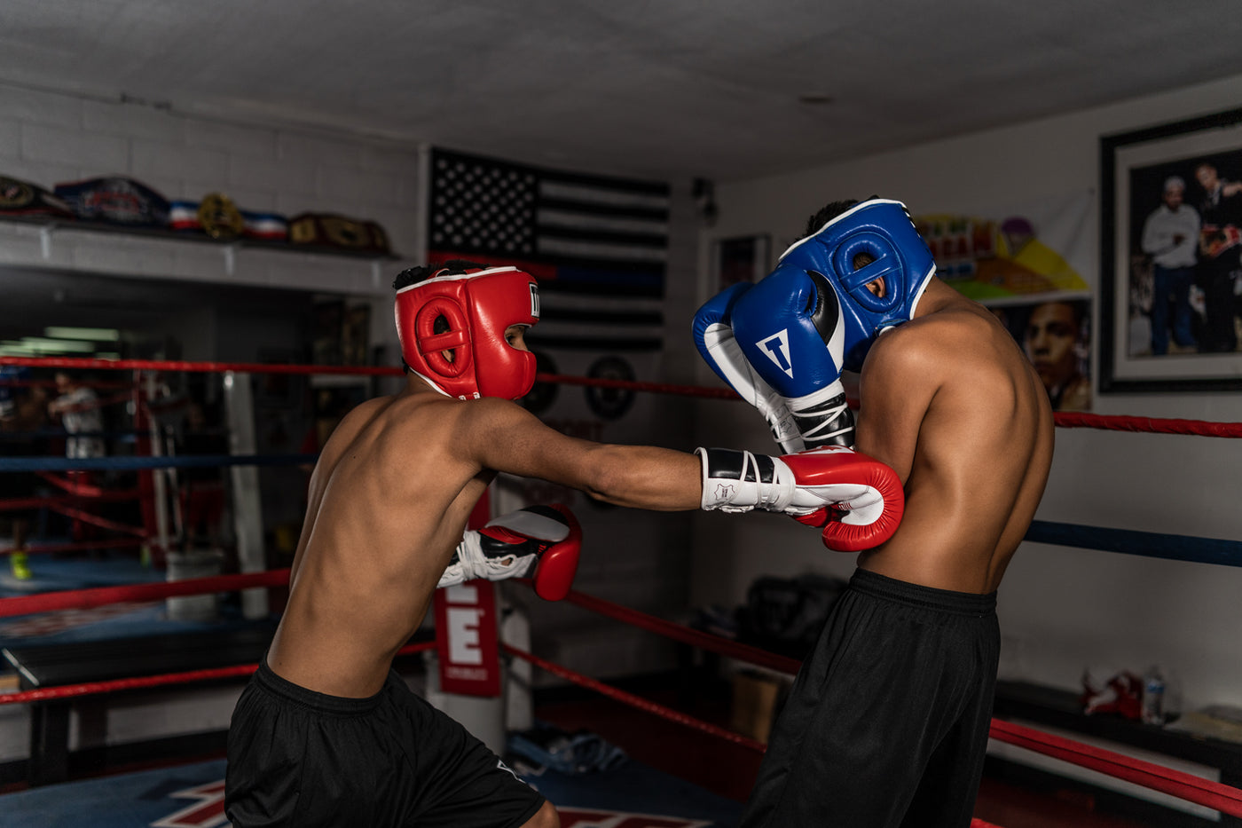 variant:lifestyle::TITLE Boxing Headgear and Groin Protector Bundle on fighters sparring in the ring