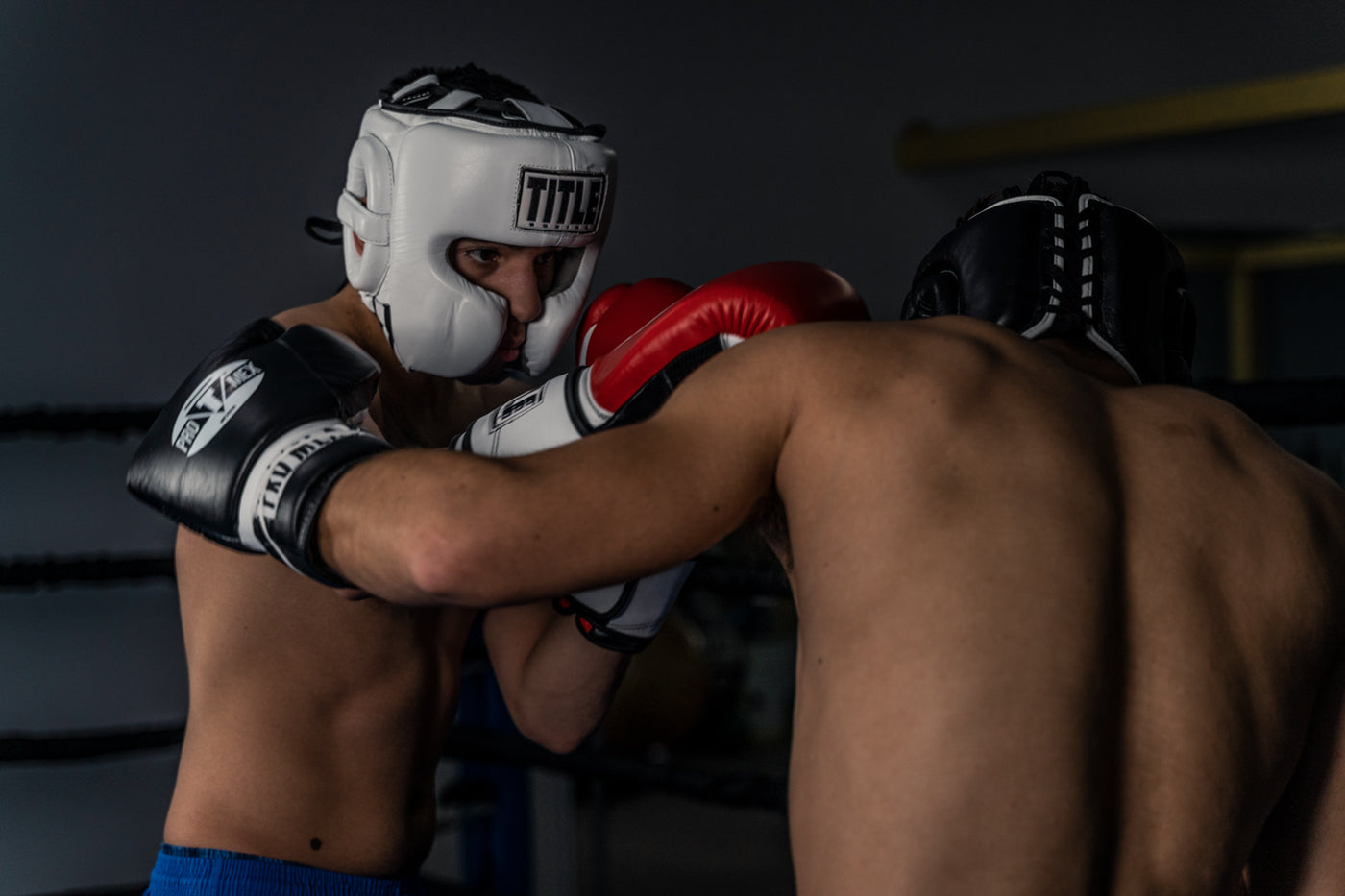 variant:white::TITLE Boxing Headgear and Groin Protector Bundle on fighters in the ring