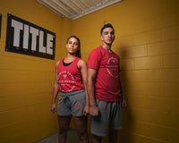 variant:lifestyle::TITLE Boxing Big Logo Banner on the wall of a gym behind two boxers