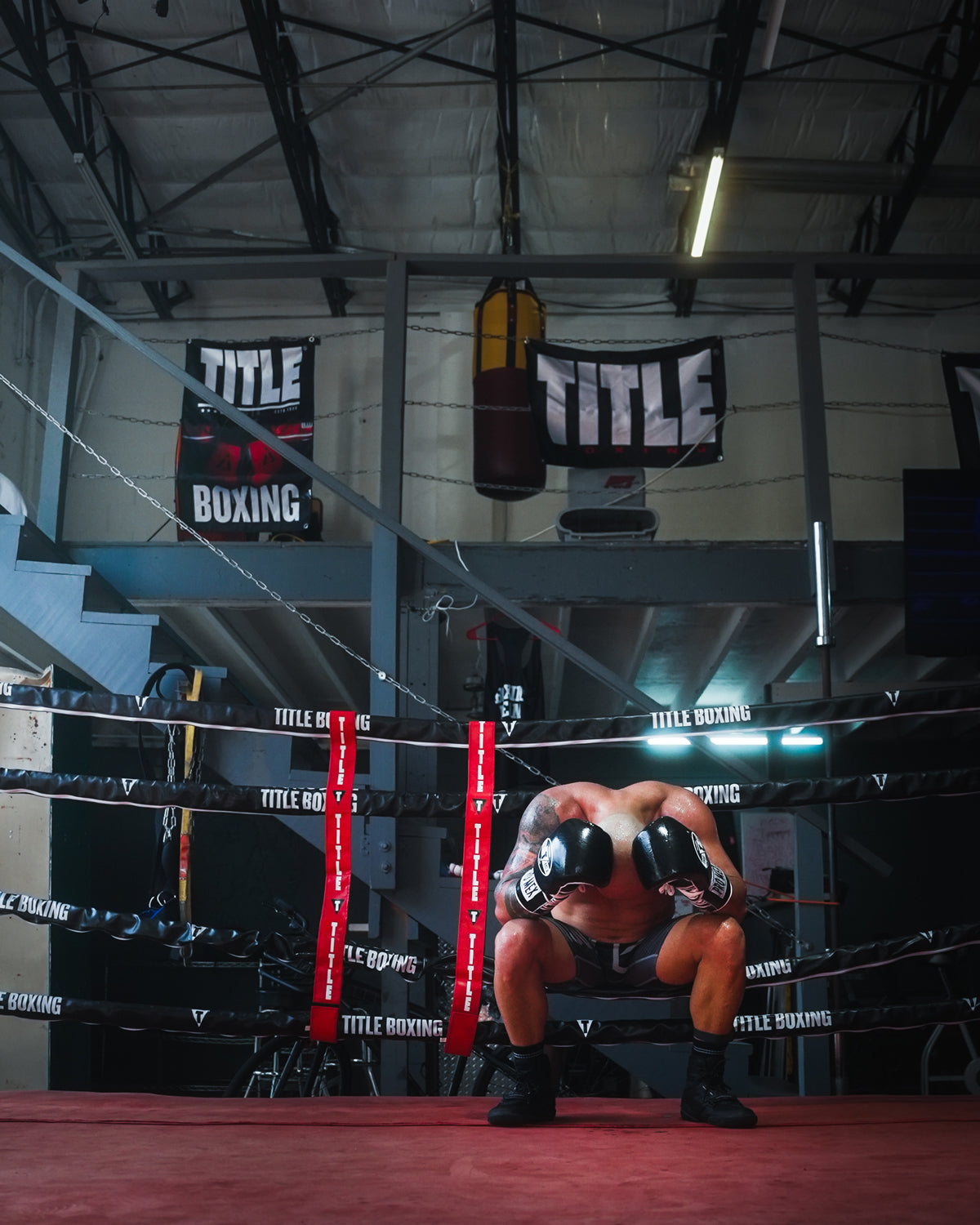 variant:lifestyle::TITLE Boxing Pro Fight Banner on wall behind boxing ring