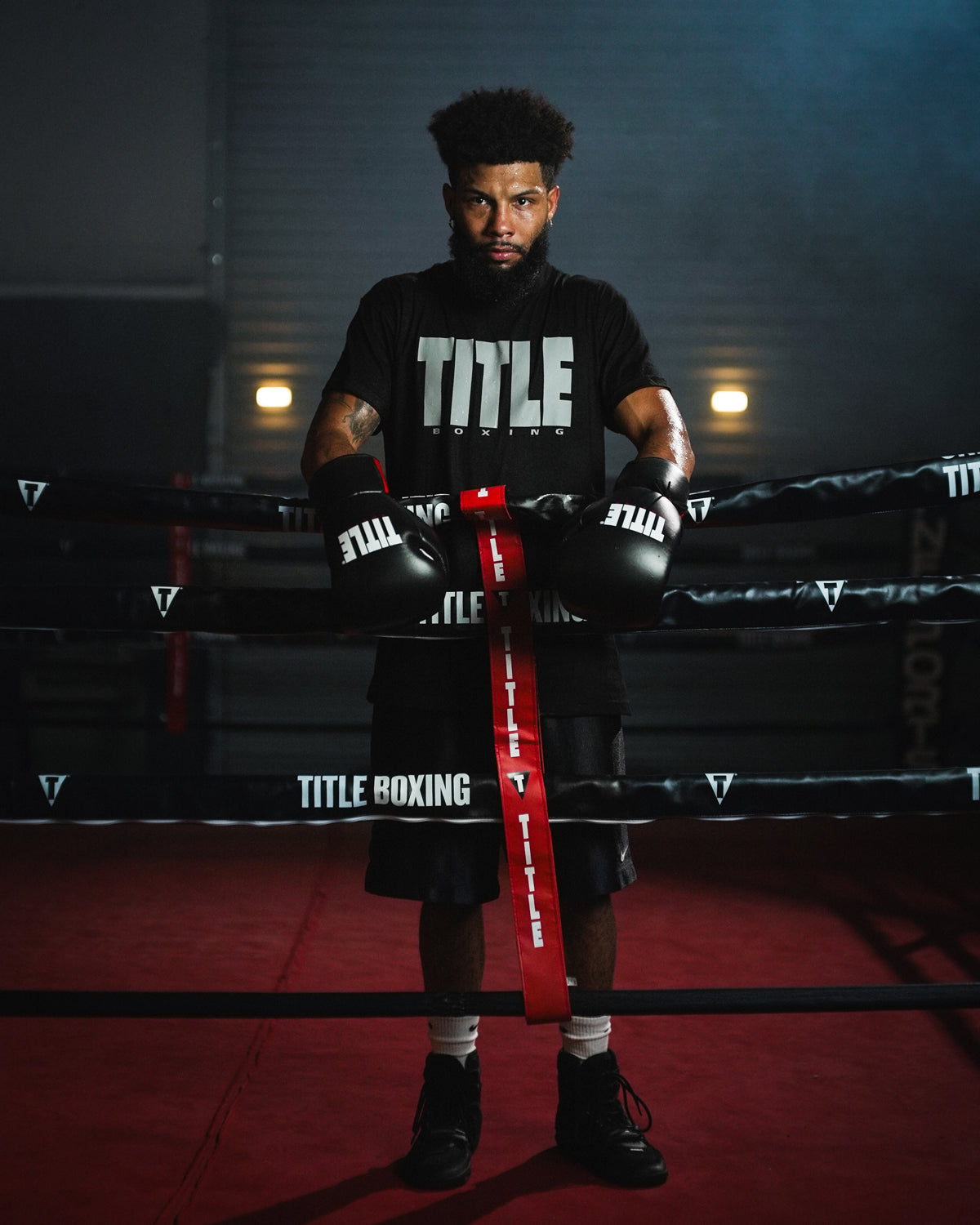 variant:lifestyle::TITLE Boxing Gel Generation Leather Lace Sparring Gloves on boxer leaning on ring ropes