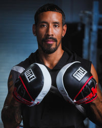 variant:lifestyle::TITLE Boxing Gel Leather Punch Mitts on fighter's hands