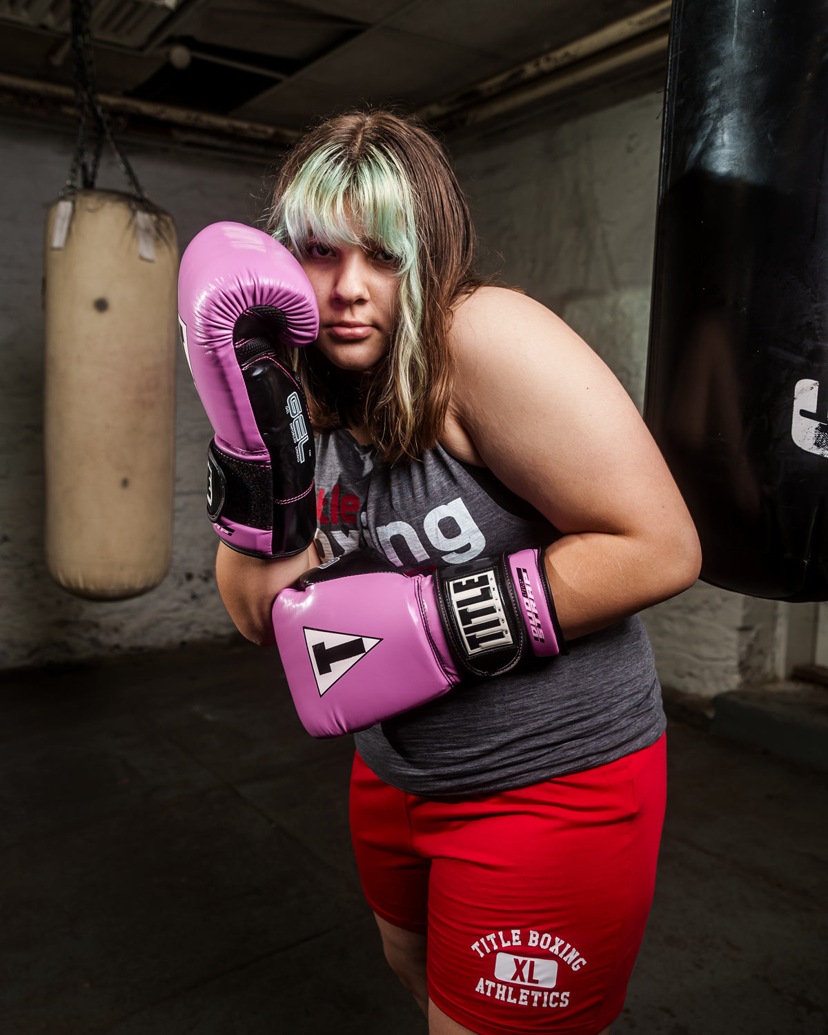 variant:purple/black::TITLE Boxing Gel Glory Super Bag Gloves 2.0 girl boxing pose