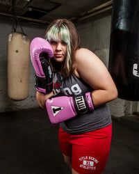 variant:purple/black::TITLE Boxing Gel Glory Super Bag Gloves 2.0 girl boxing pose