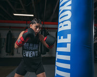 variant:lifestyle::TITLE Boxing Guts and Glory Bag Gloves girl hitting bag