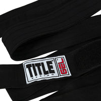 variant:black::TITLE Boxing Gel Iron Fist Wraps laid down view
