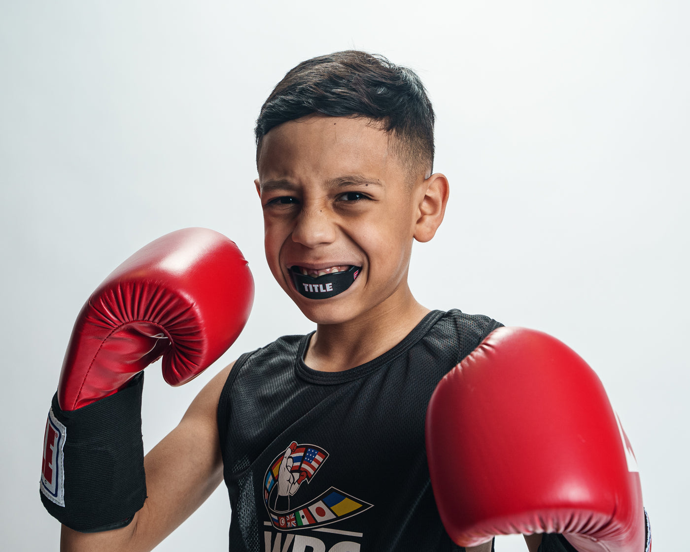 variant:black/red::TITLE Boxing Gel Max Channel Mouth Guard 2.0 kid boxing pose