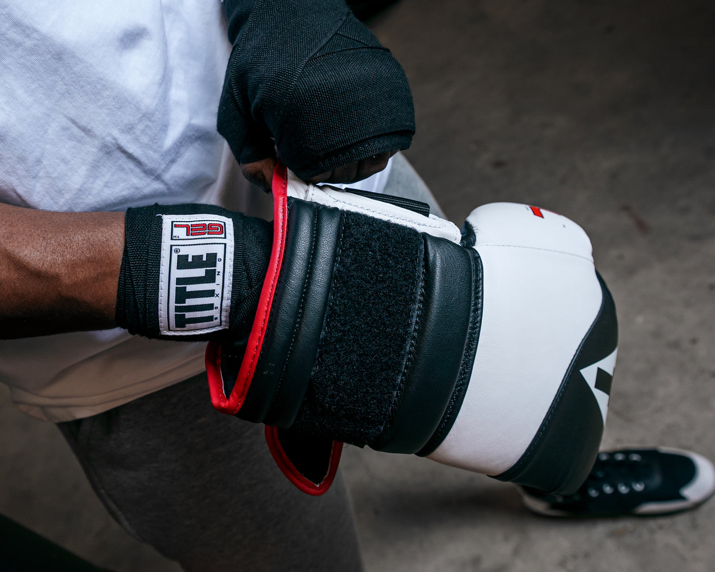 variant:Black/White::TITLE Boxing Gel Suspense Training Gloves close up on strap of glove