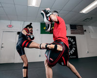 variant:lifestyle::TITLE MMA Gel Thai Style Thigh Pads 2.0 lady kicking pads