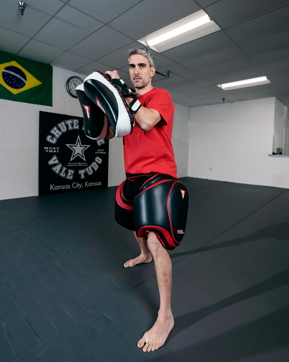 variant:lifestyle::TITLE MMA Gel Thai Style Thigh Pads 2.0 coach boxing stance
