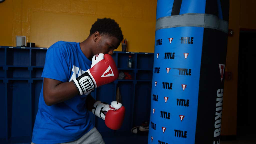 variant:Red::TITLE Boxing Gel World Bag Gloves kid hitting blue bag